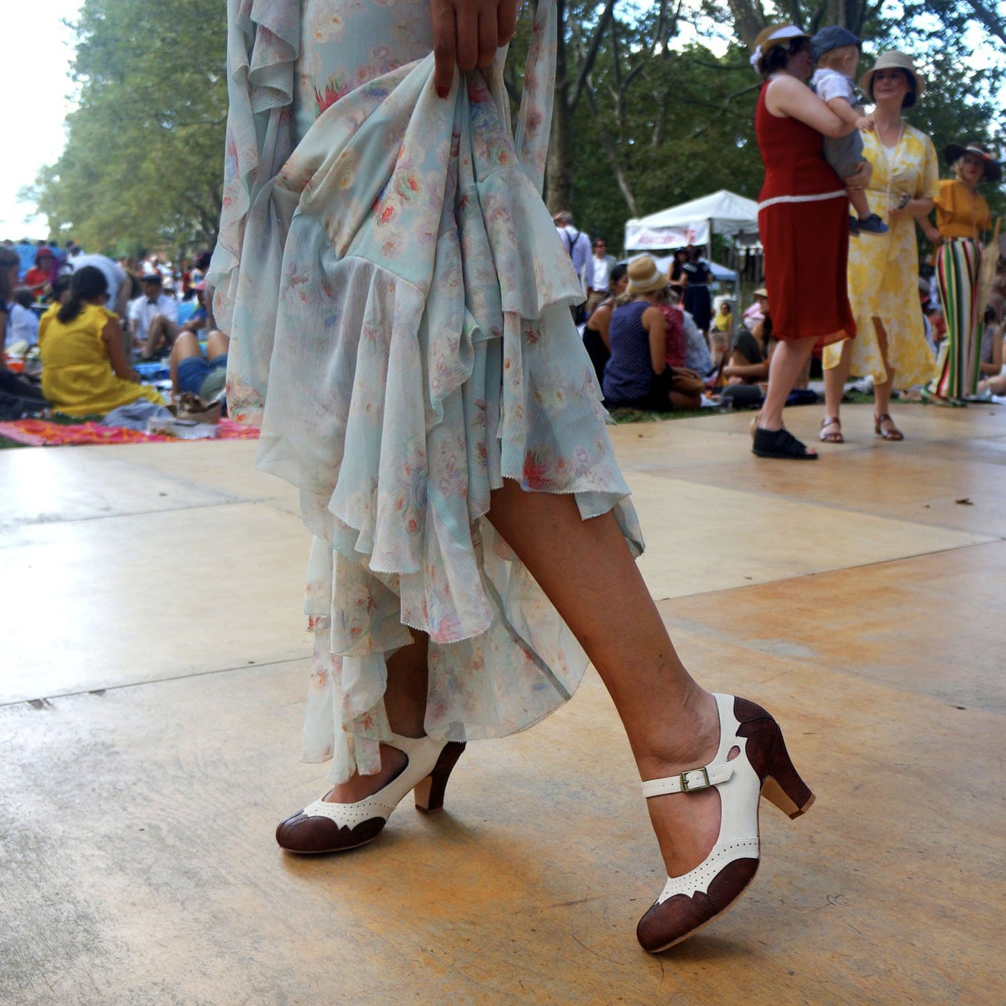 Closeup of woman wearing Aris Allen Brown and Ivory dance heels